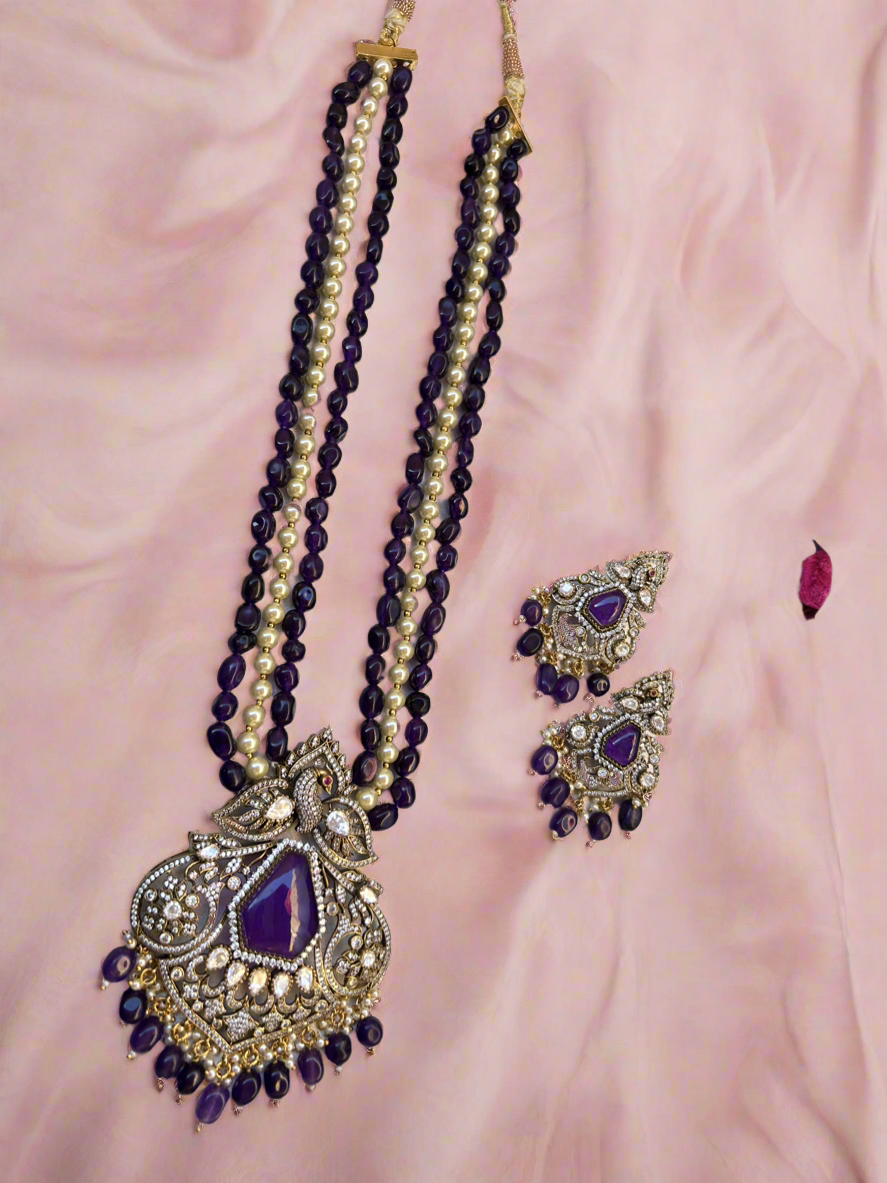 Elegant Kiara Kundan Necklace Set with purple and gold beads, featuring intricate stonework and matching earrings.