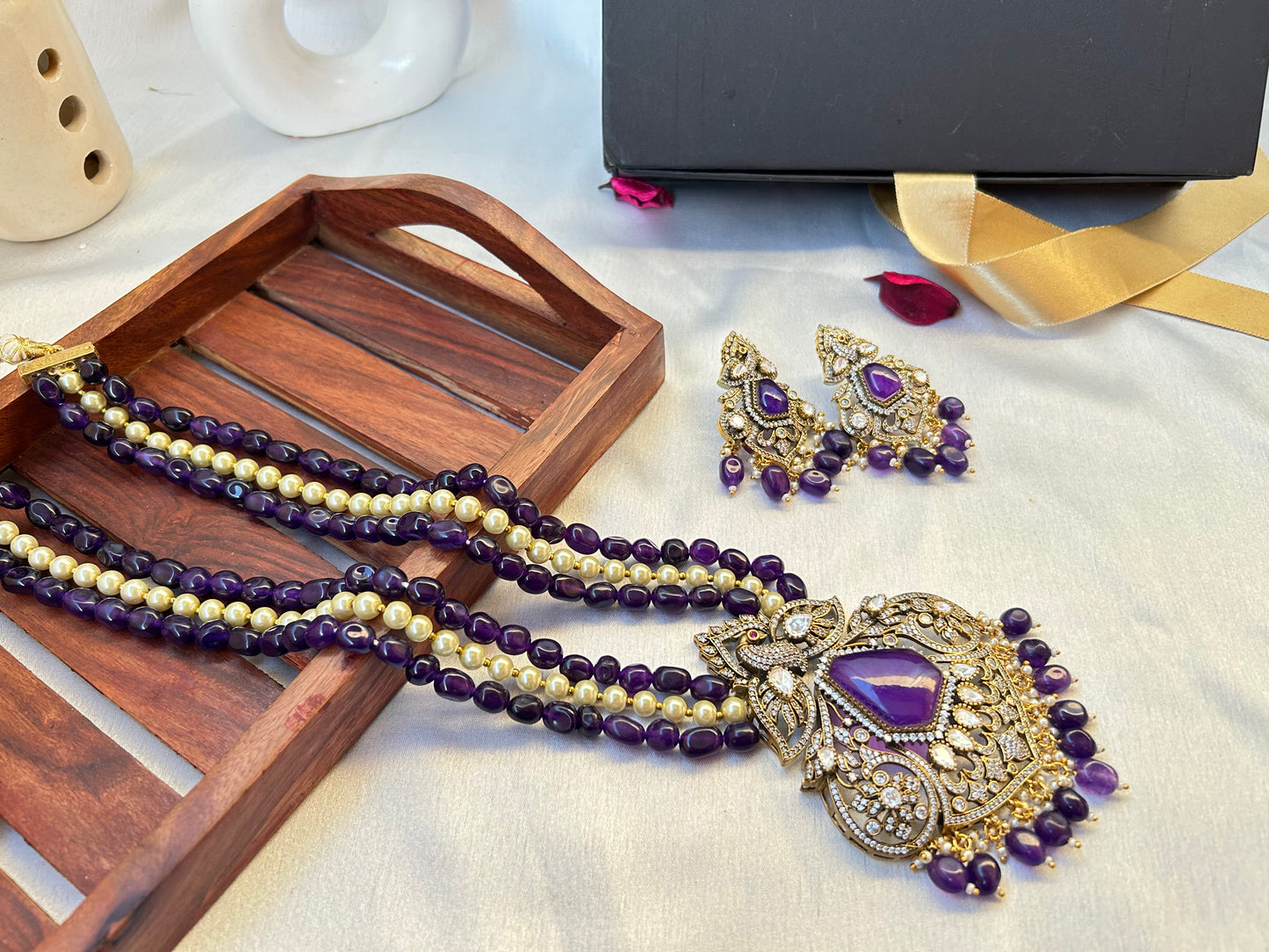 Elegant Kiara Kundan Necklace Set with purple and gold beads, featuring intricate stonework and matching earrings.