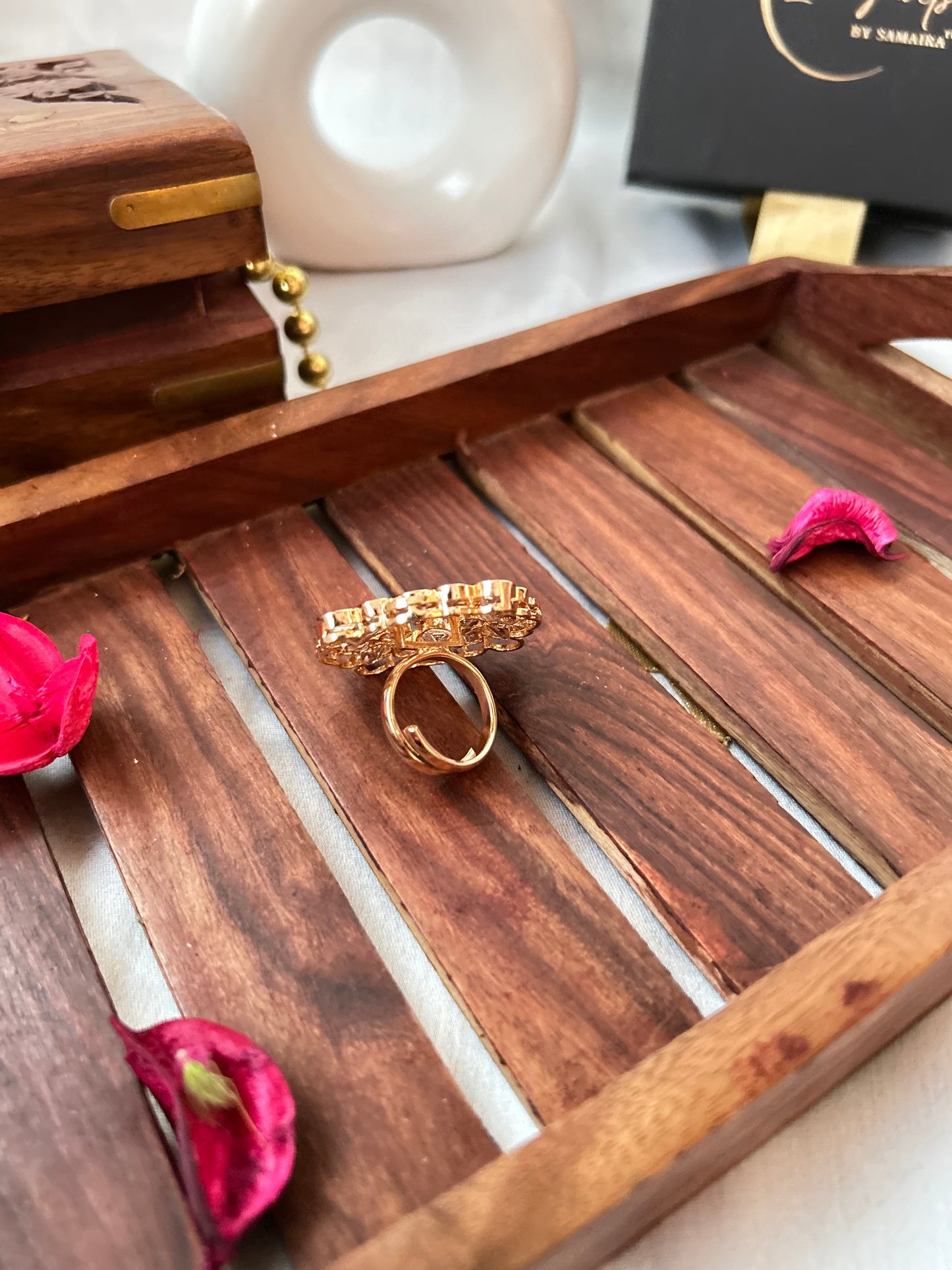 Emerald green and Kundan ring with gold-plated floral design