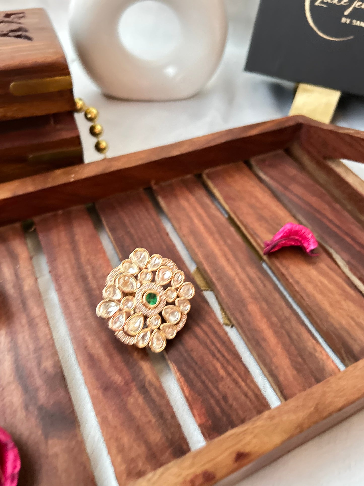 Emerald green and Kundan ring with gold-plated floral design