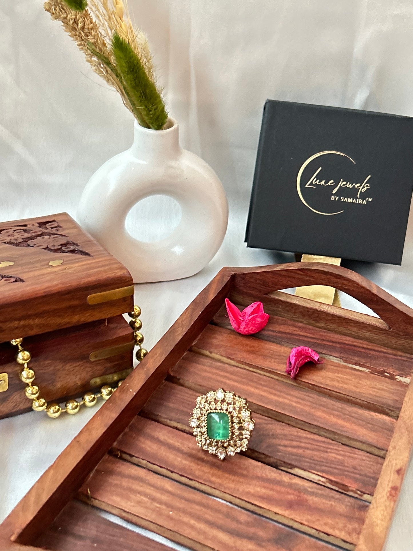 Square-cut emerald green ring with intricate gold and American diamond detailing