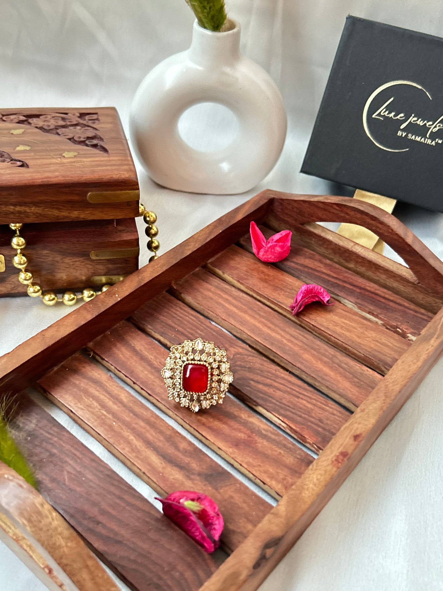 Square-cut ruby red ring with intricate gold and American diamond detailing