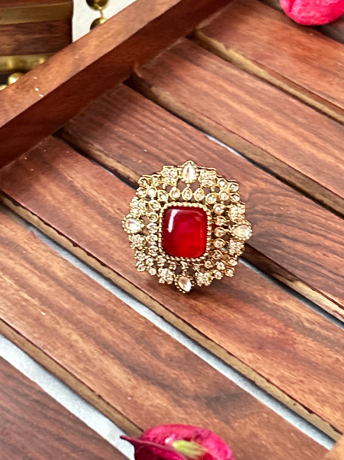 Square-cut ruby red ring with intricate gold and American diamond detailing