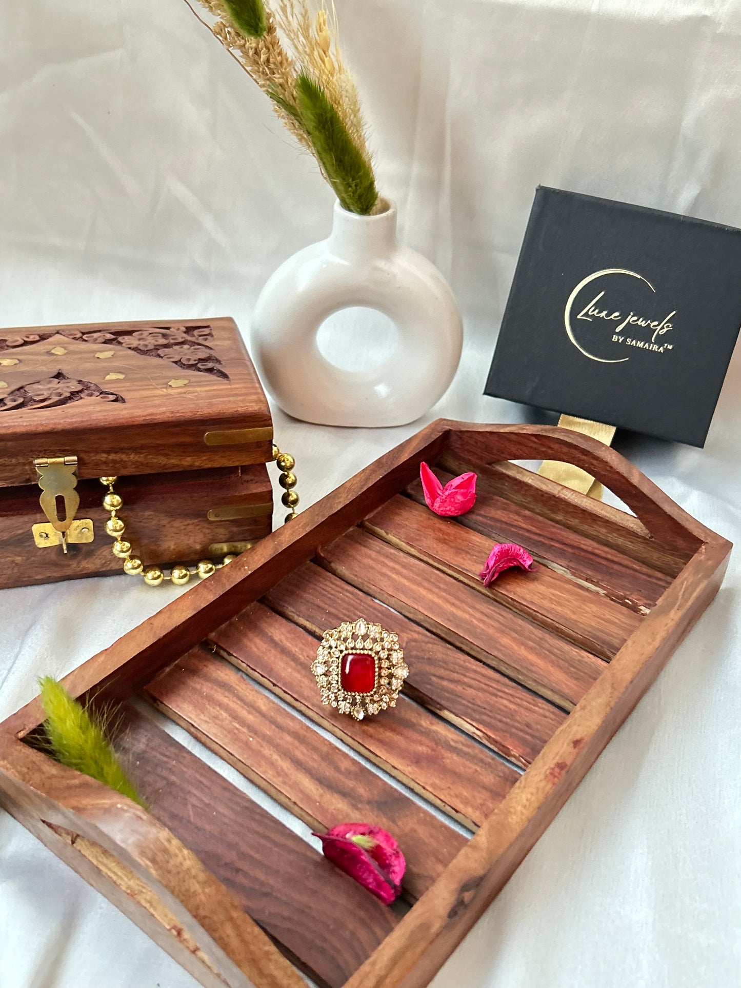 Square-cut ruby red ring with intricate gold and American diamond detailing