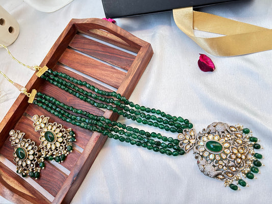 Simar Emerald Kundan Necklace Set with lush green beads, uncut Kundan stones, and matching earrings, perfect for bridal and festive wear.emerald green rani haar long necklace