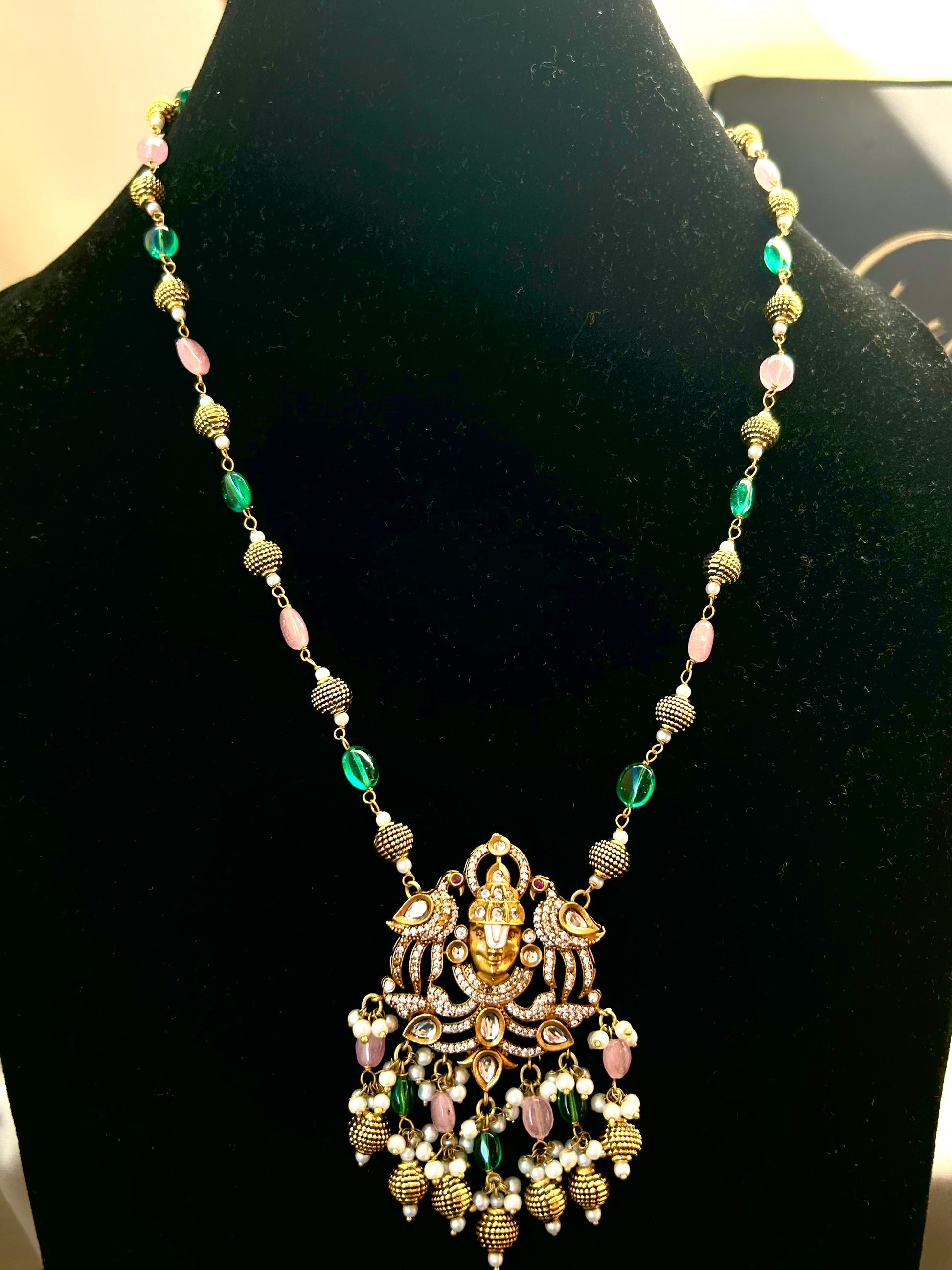 Keshavi Temple Necklace Set – Gold-plated Kundan jewelry with Goddess Lakshmi pendant, pearls, and green-pink beads"
