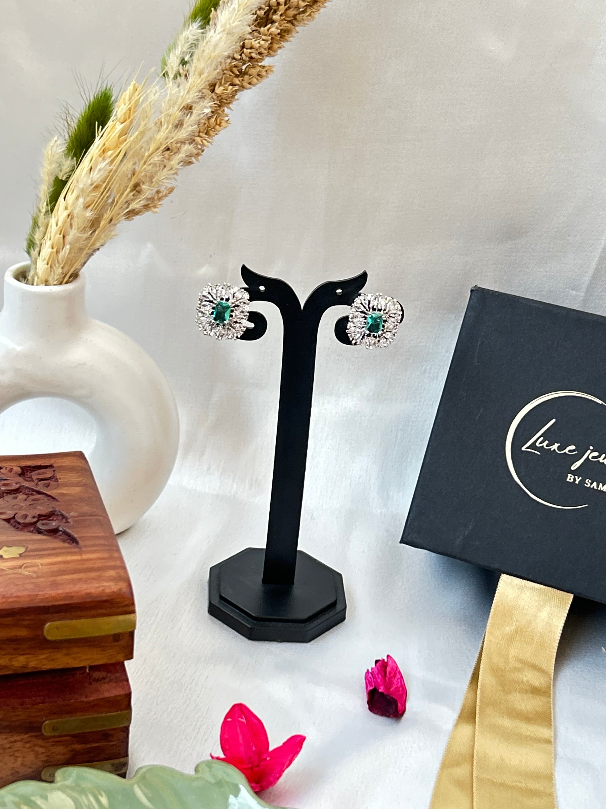 Sea green stud earrings with American diamond halo and silver-plated finish