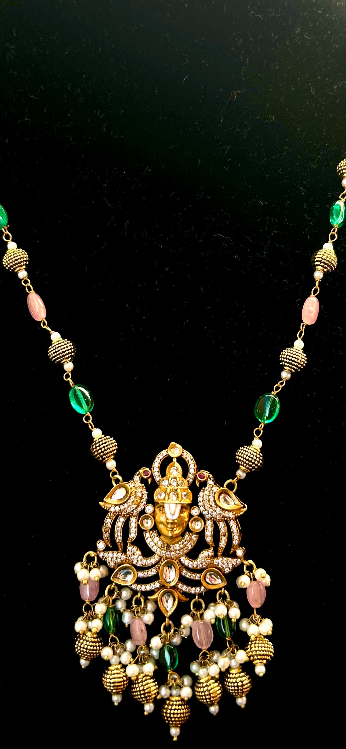 Keshavi Temple Necklace Set – Gold-plated Kundan jewelry with Goddess Lakshmi pendant, pearls, and green-pink beads"