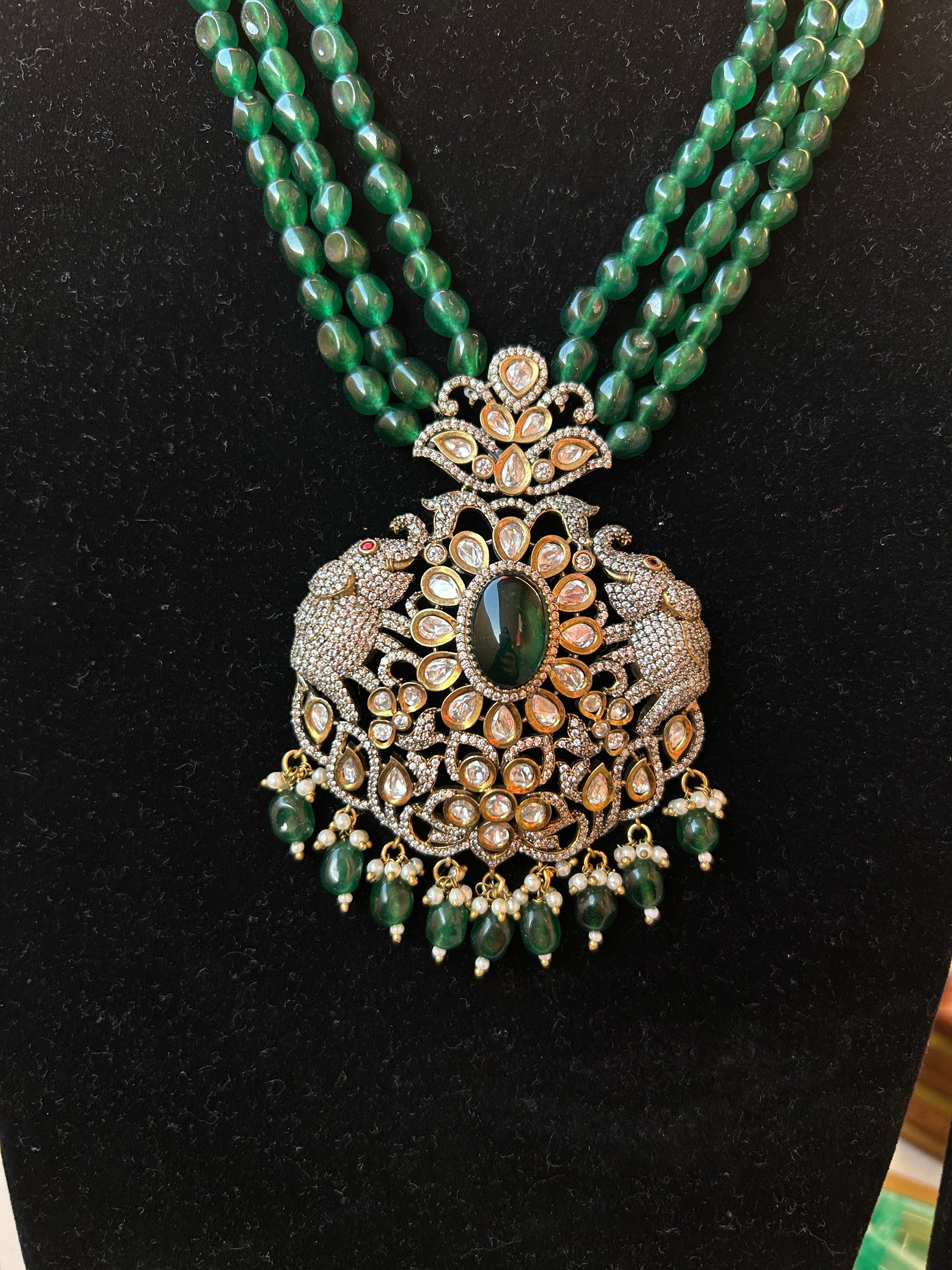 Simar Emerald Kundan Necklace Set with lush green beads, uncut Kundan stones, and matching earrings, perfect for bridal and festive wear.