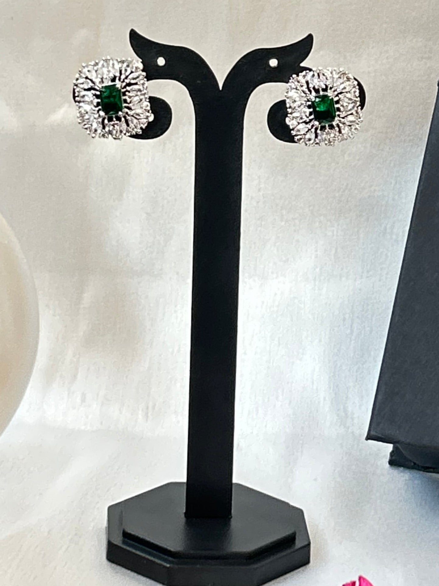 Emerald green stud earrings with American diamonds in a silver-plated setting