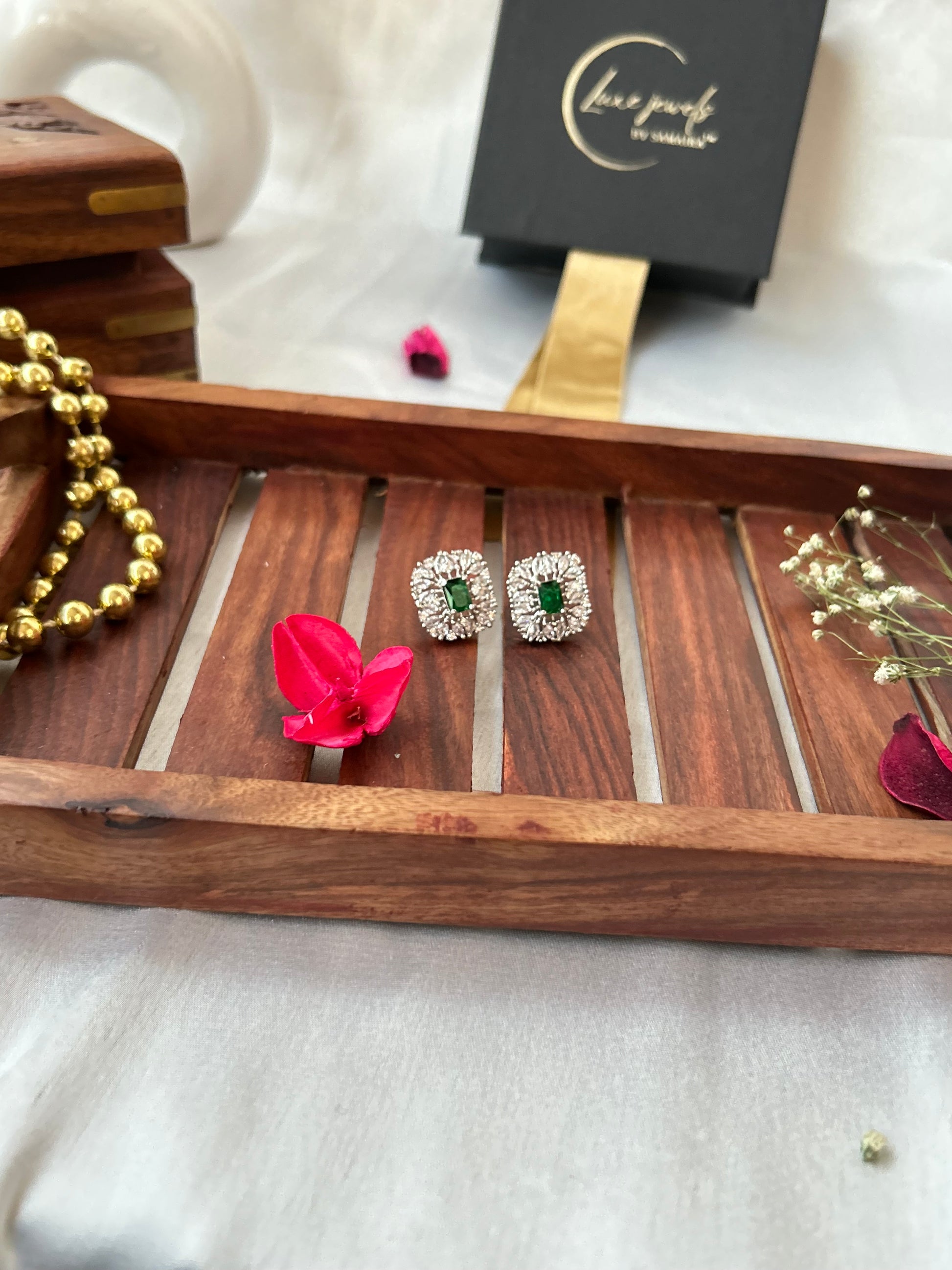 Emerald green stud earrings with American diamonds in a silver-plated setting