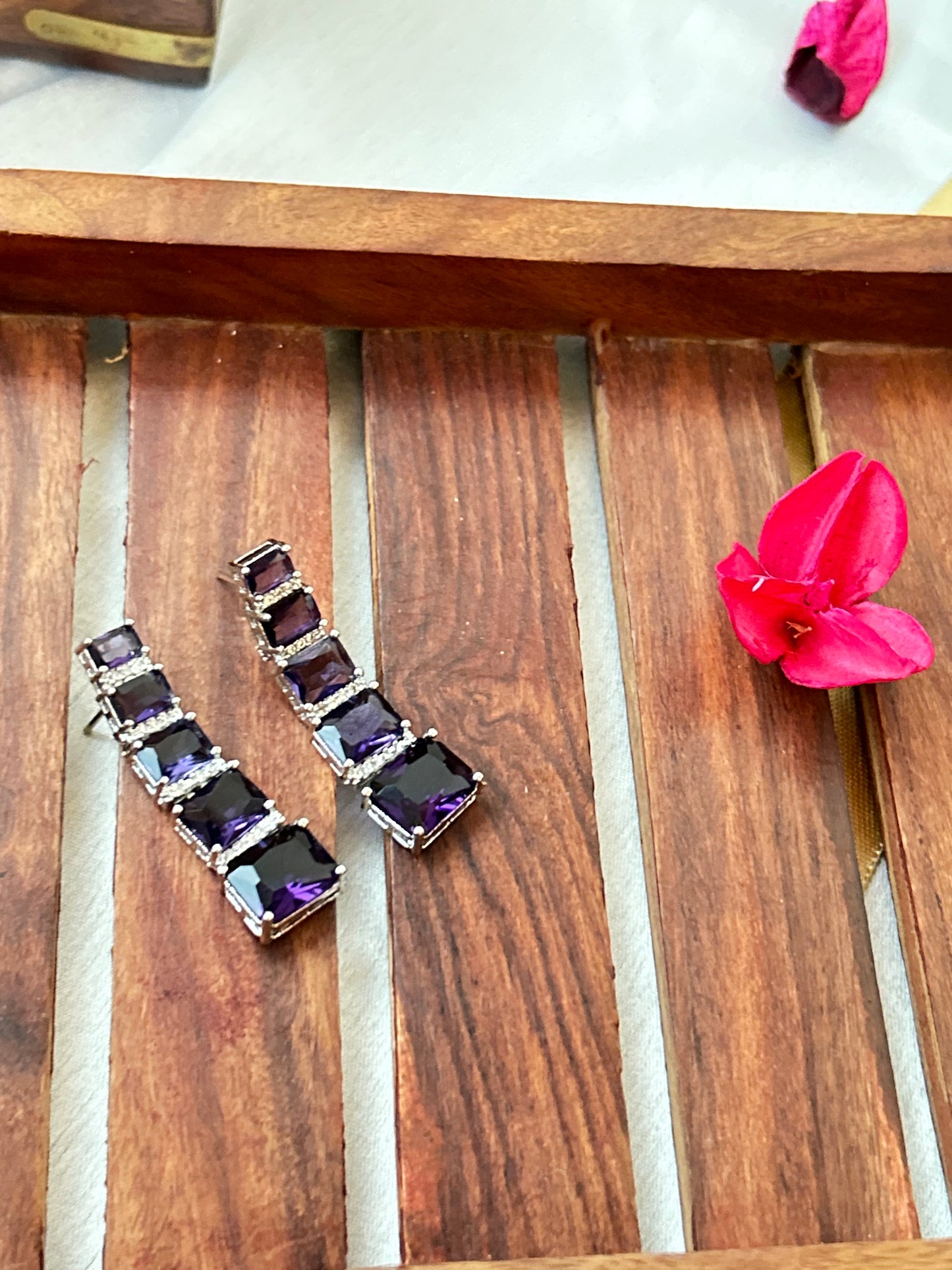 Long violet-purple earrings with American diamonds and white gold plating.