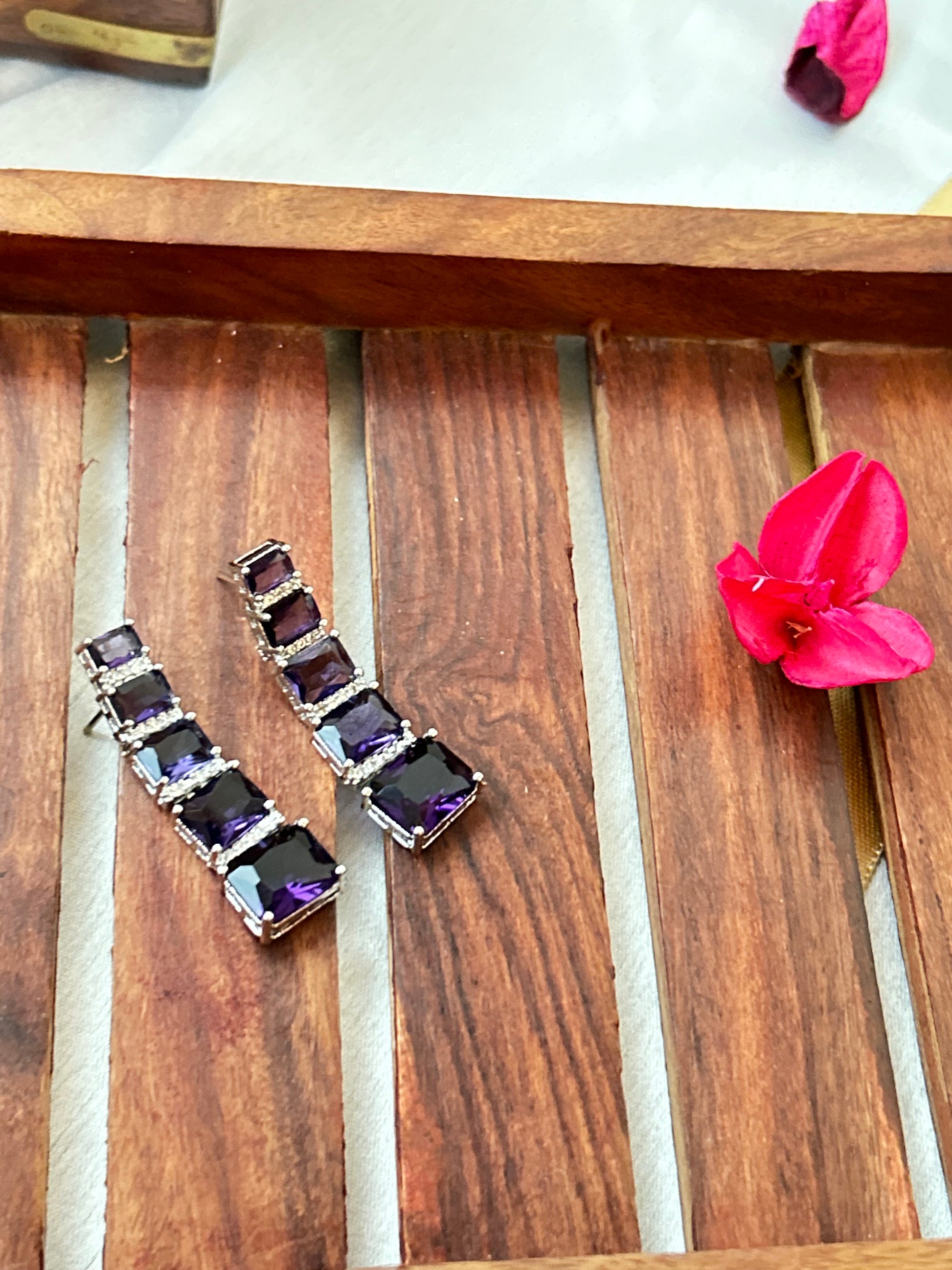Long violet-purple earrings with American diamonds and white gold plating.