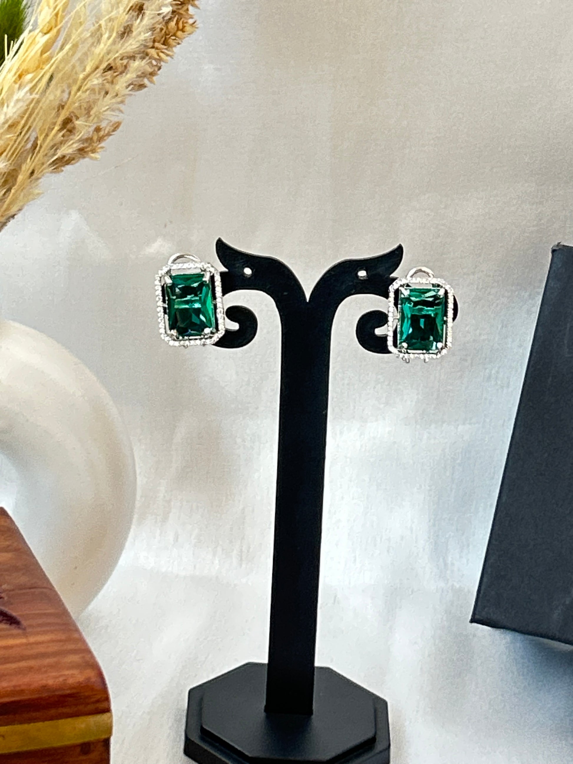 sea green stud earrings with an American diamond halo in a silver-plated setting