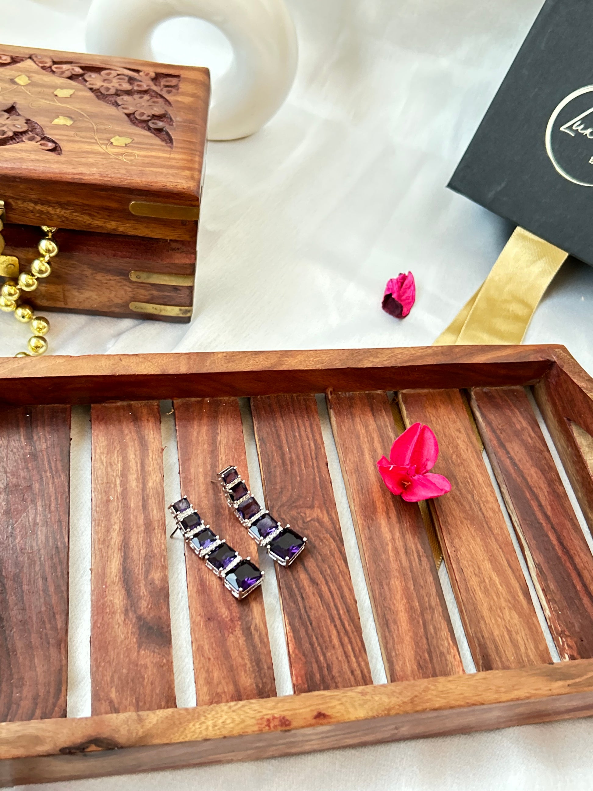 Long violet-purple earrings with American diamonds and white gold plating.