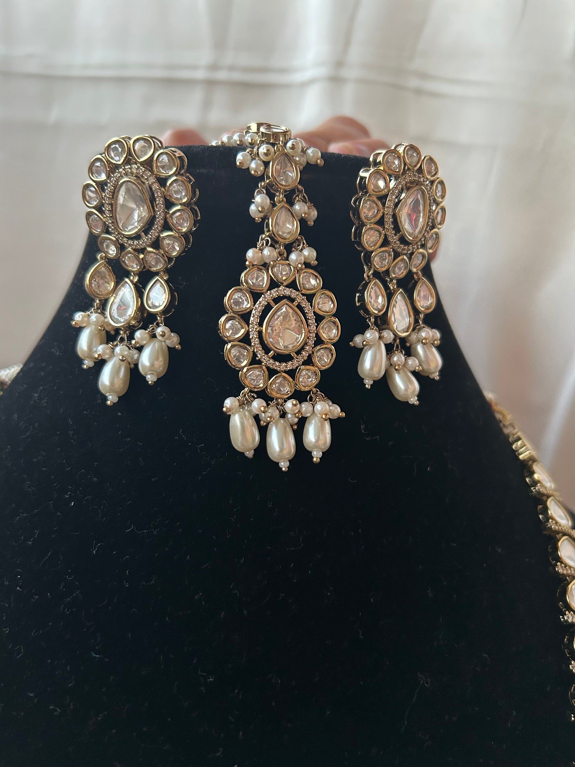 Tashi Kundan Rani Haar (long necklace set with tika )with ivory pearl drops, a regal choice for bridal and festive occasions."
