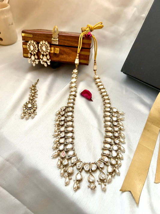 Tashi Kundan Rani Haar (long necklace set with tika )with ivory pearl drops, a regal choice for bridal and festive occasions."