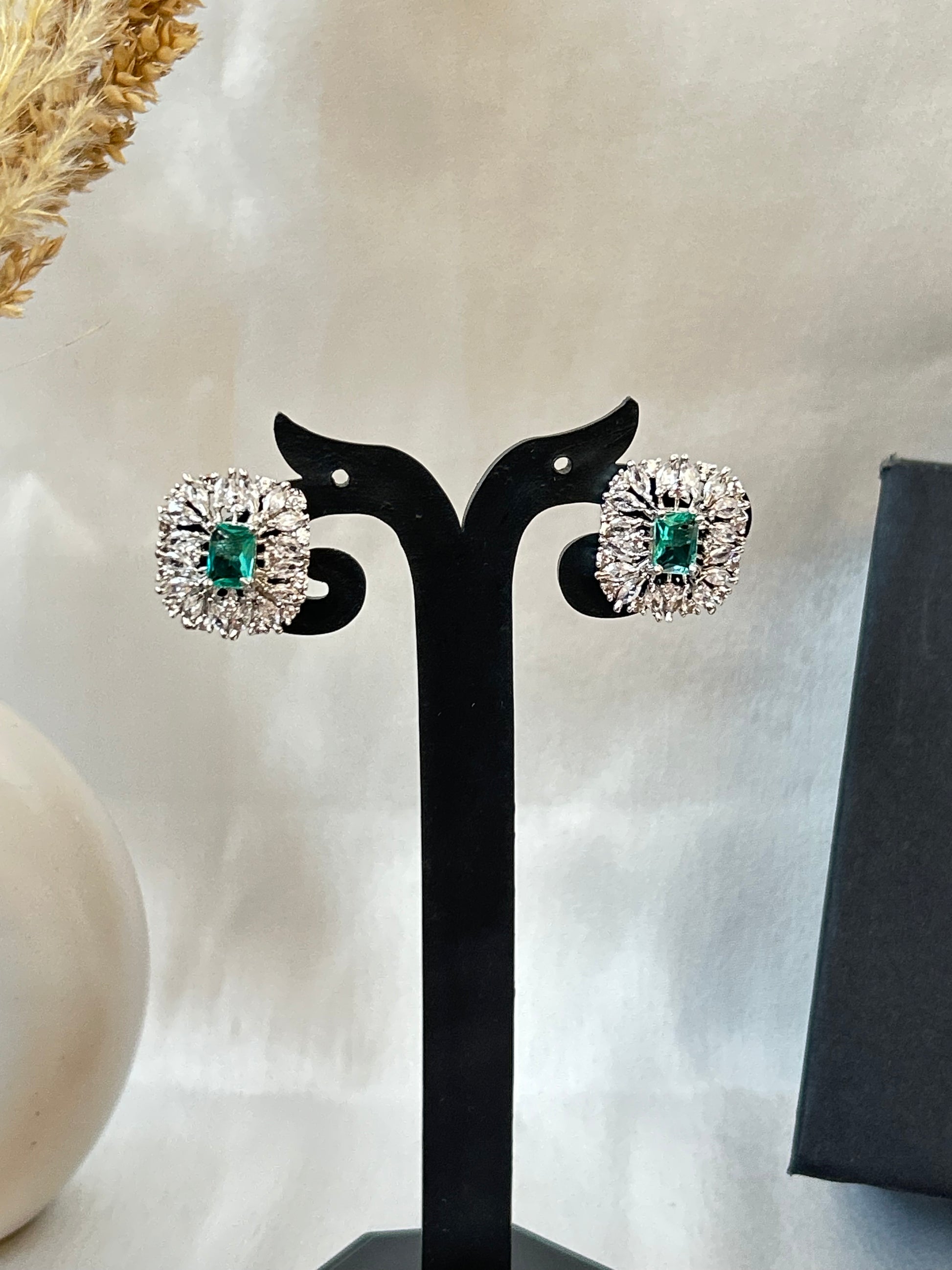 Sea green stud earrings with American diamond halo and silver-plated finish