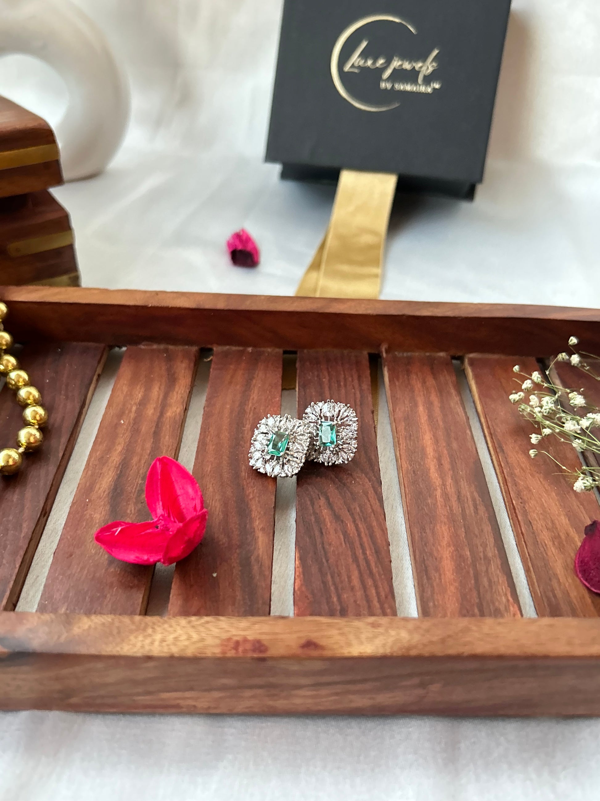 Sea green stud earrings with American diamond halo and silver-plated finish