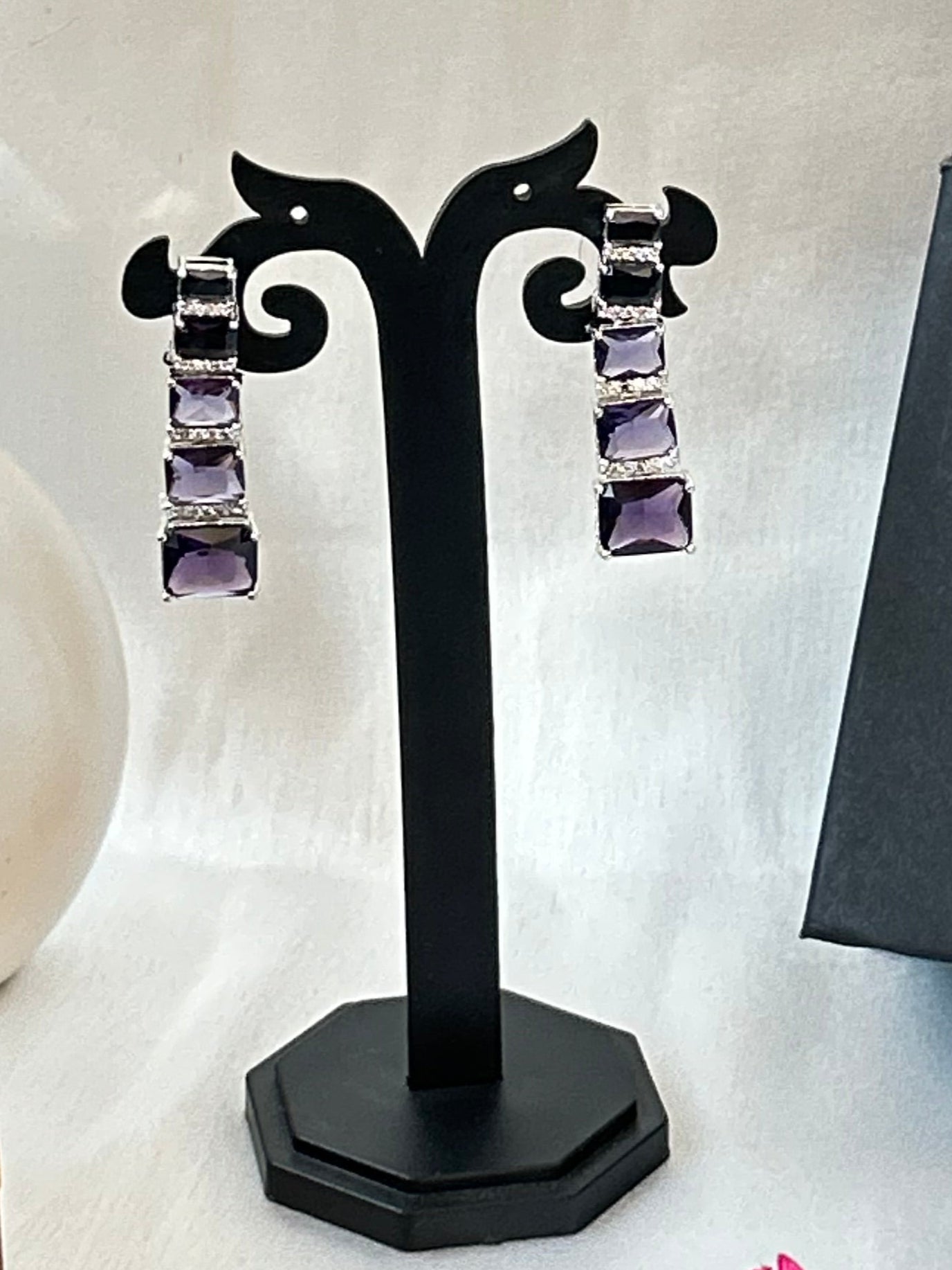 Long violet-purple earrings with American diamonds and white gold plating.