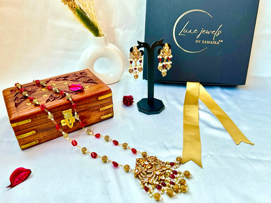 Keshavi Kundan necklace set with red beads and pearls, perfect for weddings and festive wear."