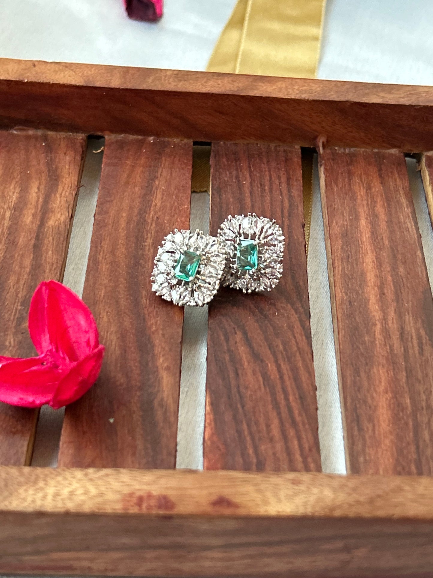 Sea green stud earrings with American diamond halo and silver-plated finish