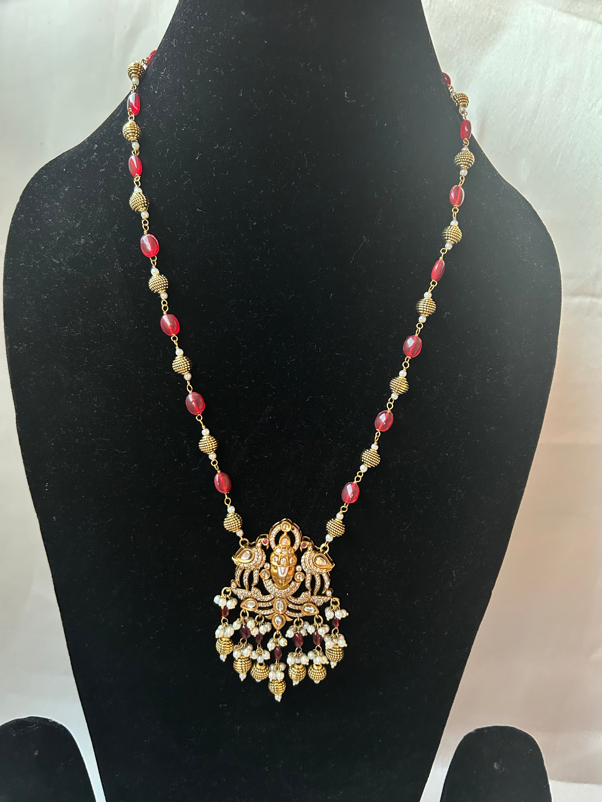 Keshavi Kundan necklace set with red beads and pearls, perfect for weddings and festive wear."
