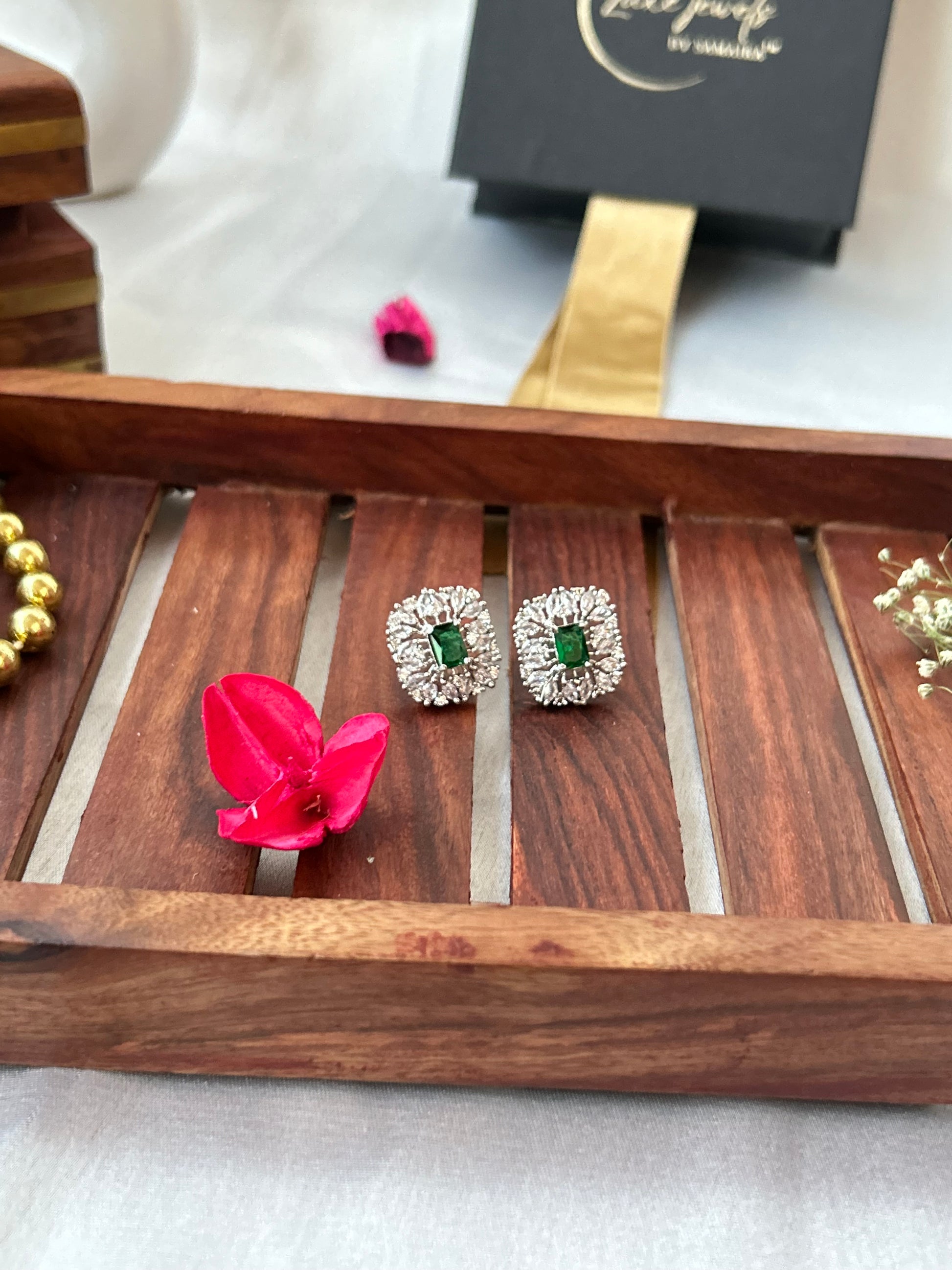 Emerald green stud earrings with American diamonds in a silver-plated setting