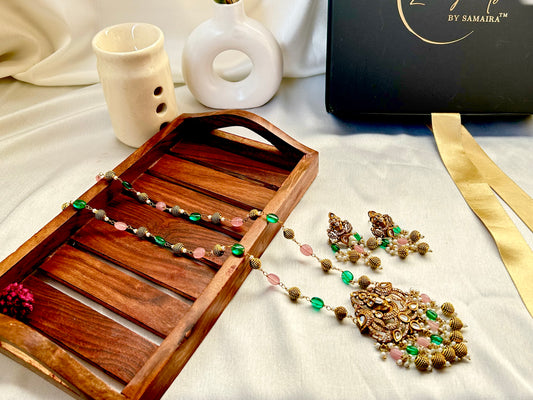 Keshavi Temple Necklace Set – Gold-plated Kundan jewelry with Goddess Lakshmi pendant, pearls, and green-pink beads"