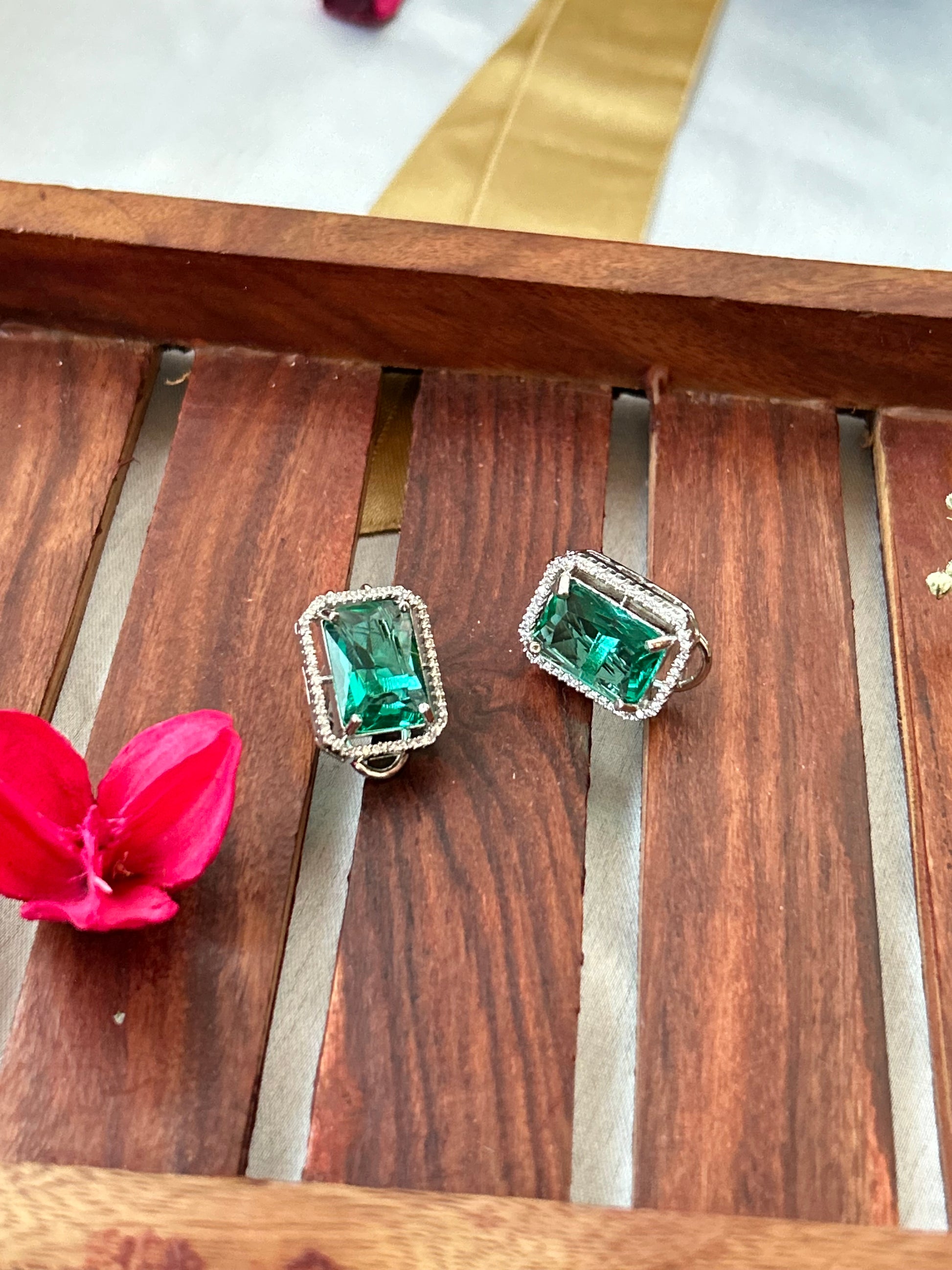 sea green stud earrings with an American diamond halo in a silver-plated setting