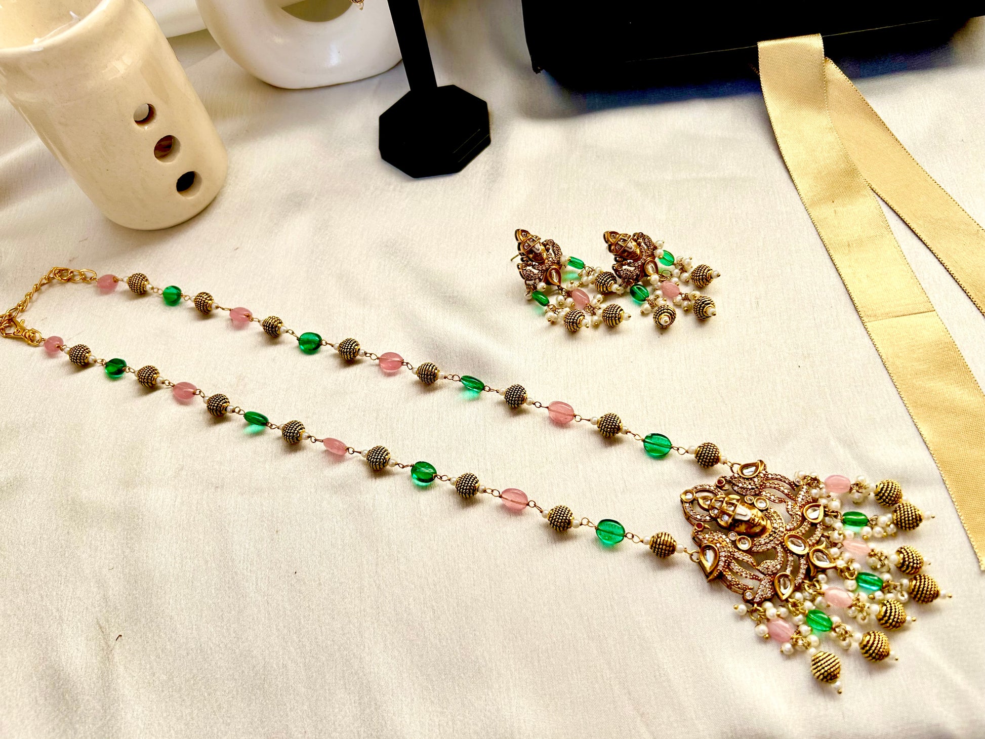 Keshavi Temple Necklace Set – Gold-plated Kundan jewelry with Goddess Lakshmi pendant, pearls, and green-pink beads"