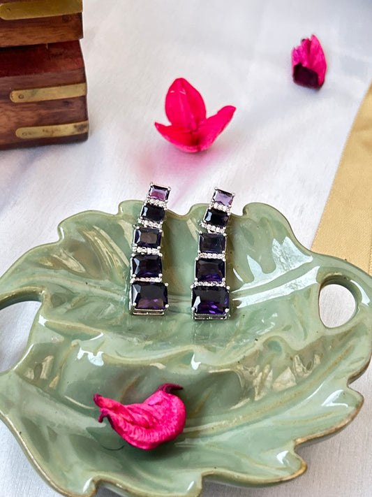 Long violet-purple earrings with American diamonds and white gold plating.