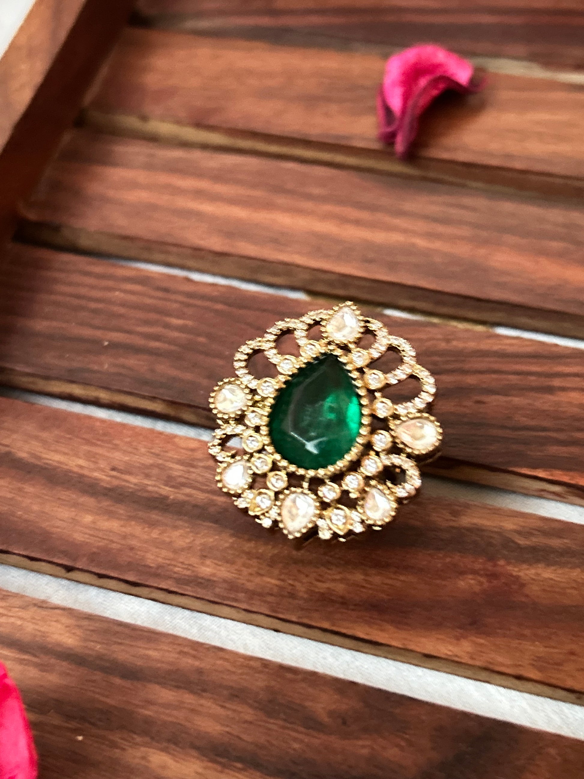 Floral emerald green ring with American diamonds and gold finish