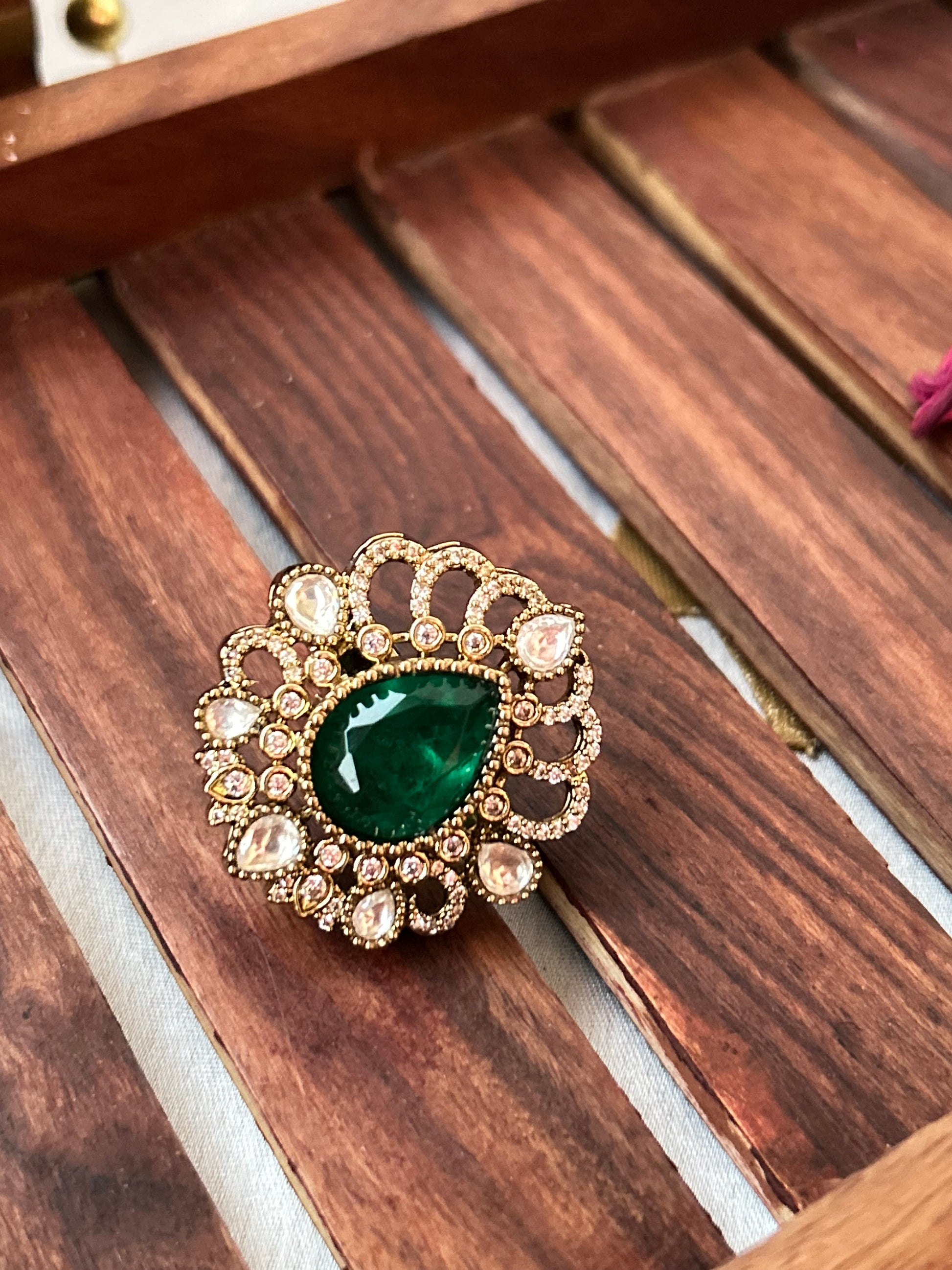 Floral emerald green ring with American diamonds and gold finish
