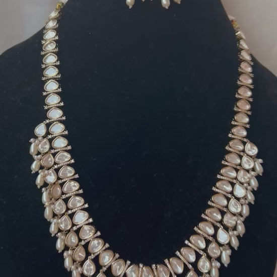 Tashi Kundan Rani Haar (long necklace set with tika )with ivory pearl drops, a regal choice for bridal and festive occasions."